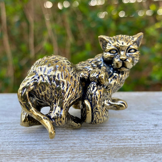 Solid brass cat and mouse figurines by Wild Brass, symbolizing balance, coexistence, and curiosity, displayed together.