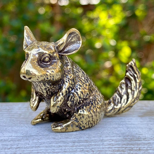 Solid brass chinchilla figurine by Wild Brass, symbolizing joy, curiosity, and calm spirit, shown in a detailed close-up image.