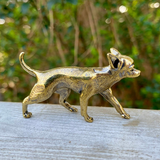 Solid brass Chihuahua dog figurine by Wild Brass, symbol of loyalty, energy, and courage, shown in a detailed close-up.