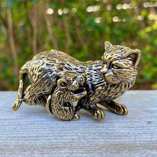 Solid brass cat and mouse figurines by Wild Brass, symbolizing balance, coexistence, and curiosity, shown together in the image.